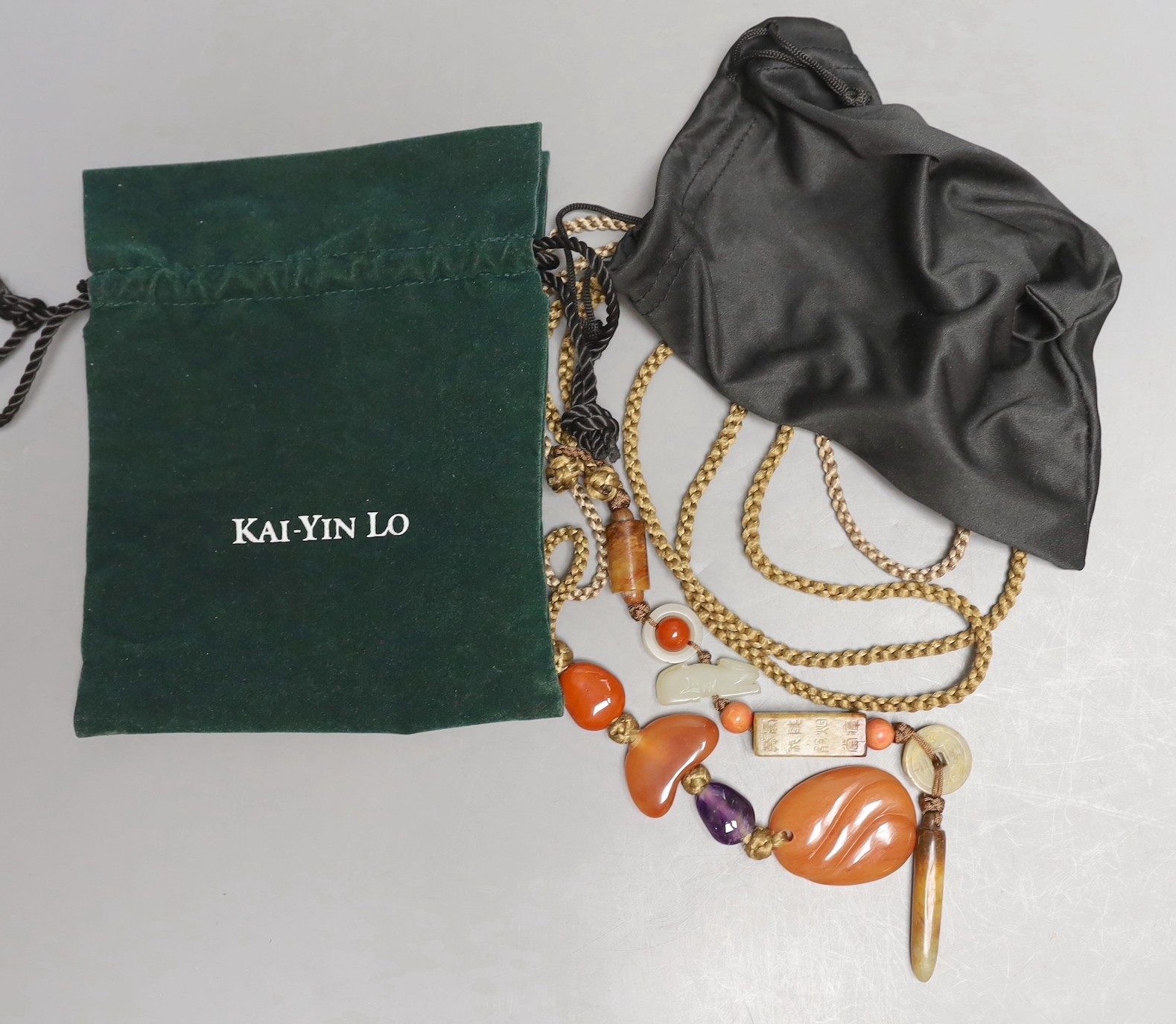 Kai Yin Lo, Hong Kong, A jade and coral mounted necklace and an agate and amethyst mounted necklace